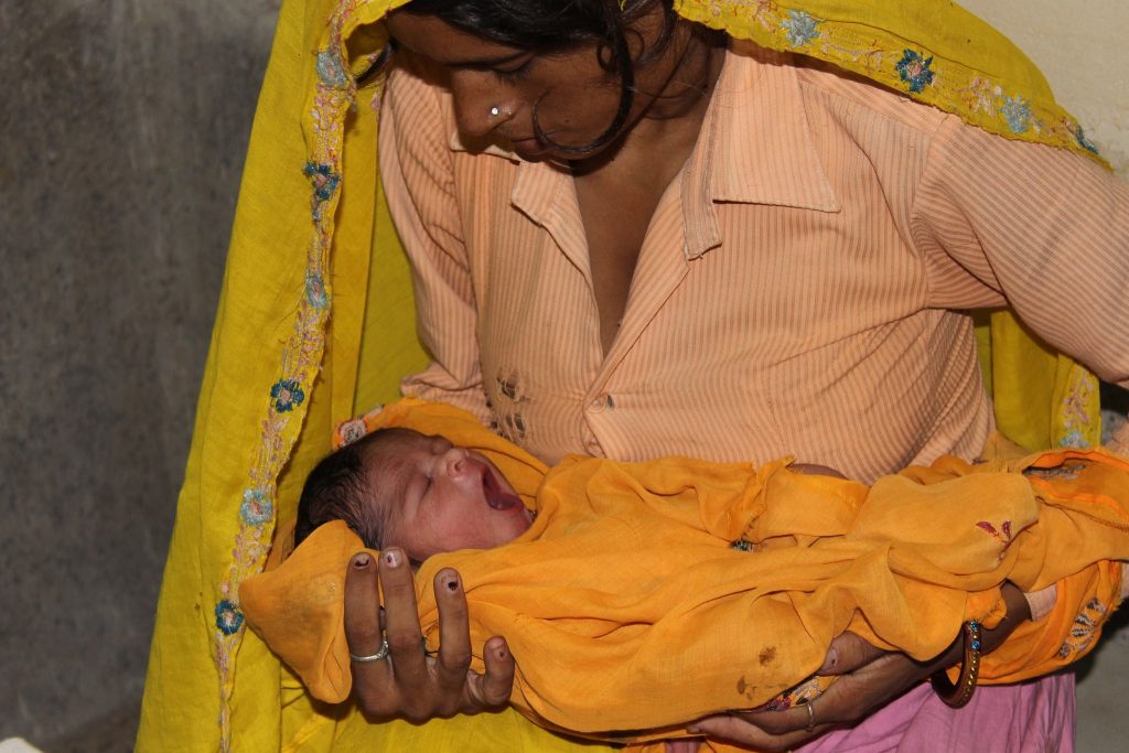 Mother in India with new baby.