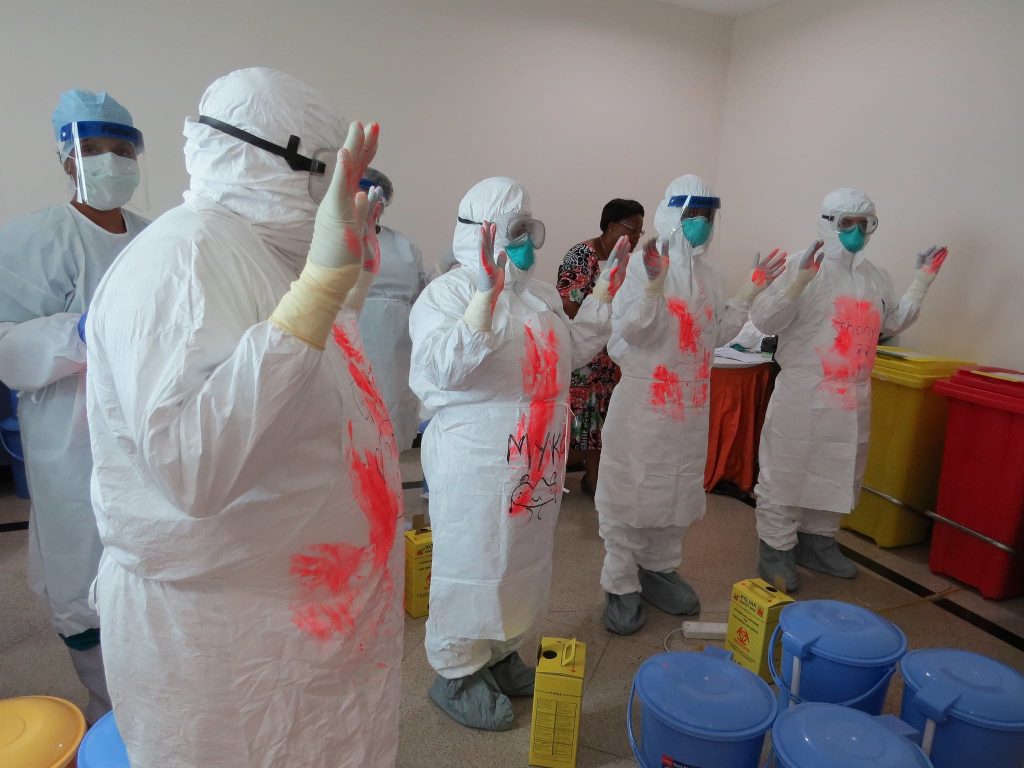 Health workers in protective suits.