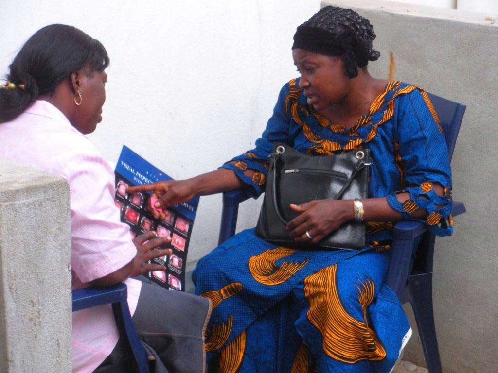 Health worker showing an illustrated chart to a client.