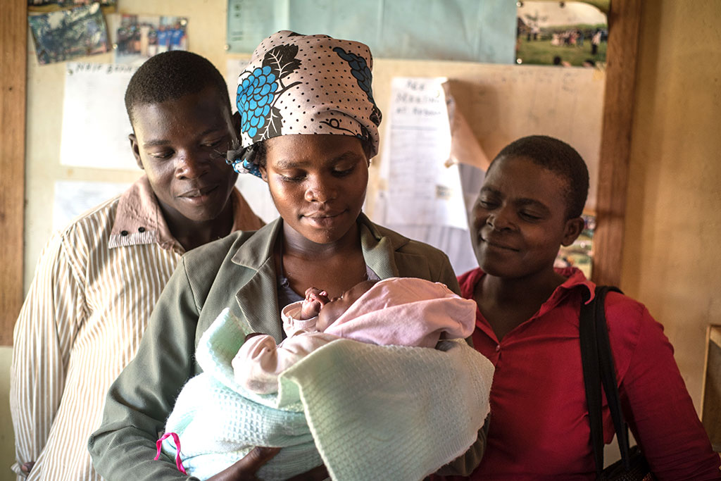 Sarah Naisambu and her husband Ishmael holding daughter