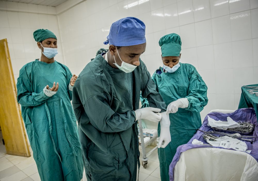 Three doctors preparing for surgery.