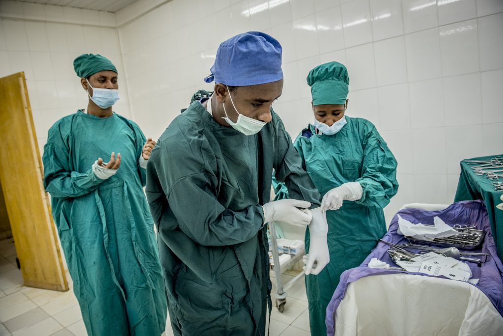 Three doctors preparing for surgery.