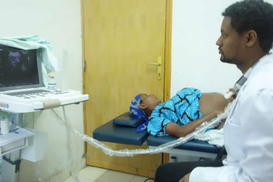 man performing ultrasound exam on woman