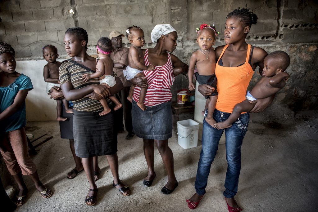 Group of women standing and holding young children