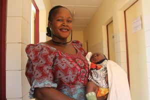 Woman smiling and holding baby