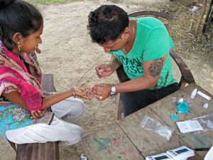 Man and woman sitting during malaria testing