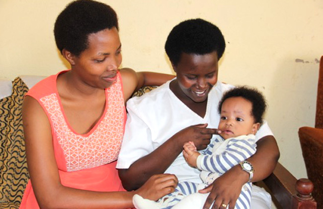 Two women, one holding baby