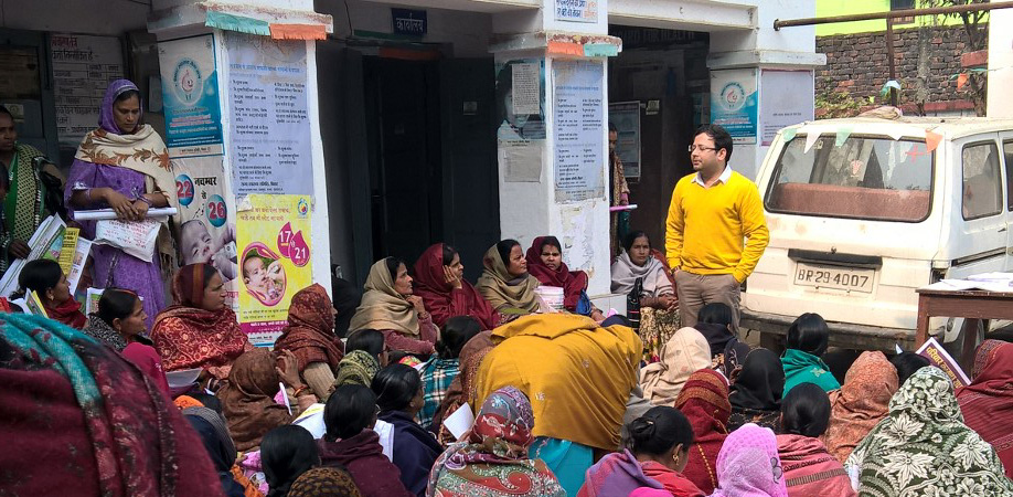 Man talking to group of seated women