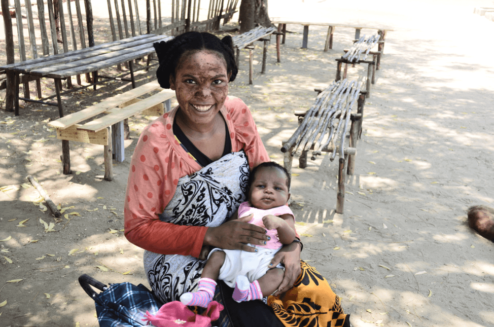 Woman sitting and holding baby