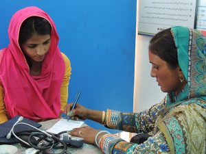 Two women sitting and filling out a form