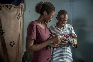 man holding baby with woman next to him