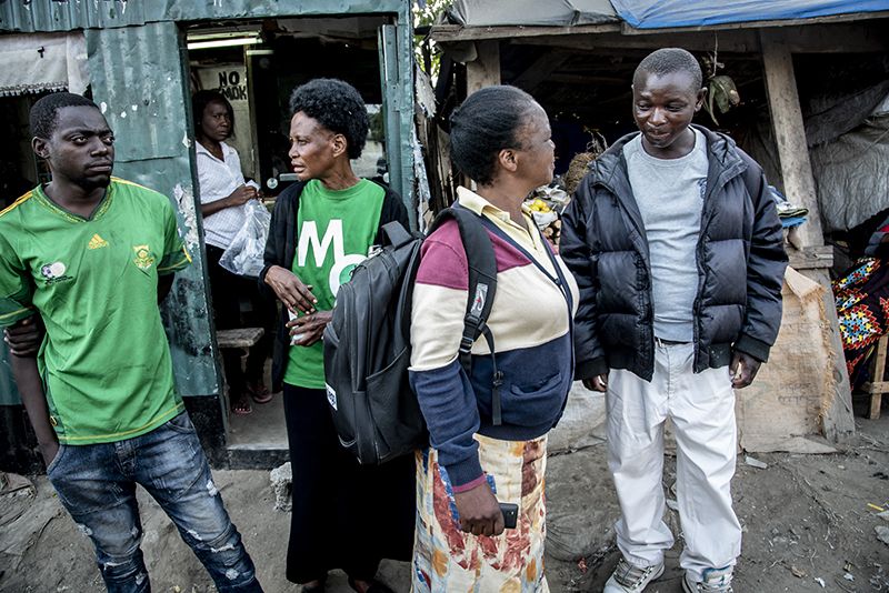 Two women and two men standing and talking