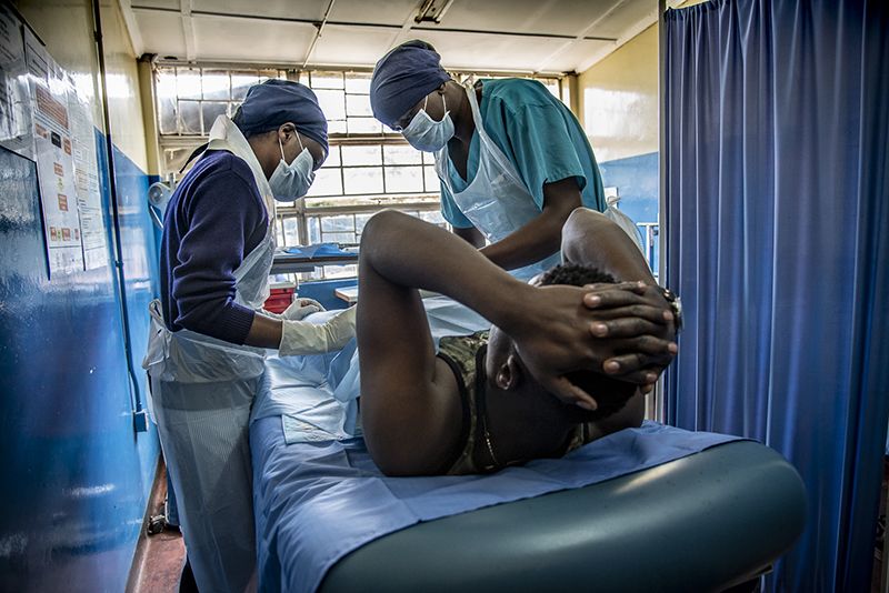 Man laying on surgical table while a male and female provider stand over