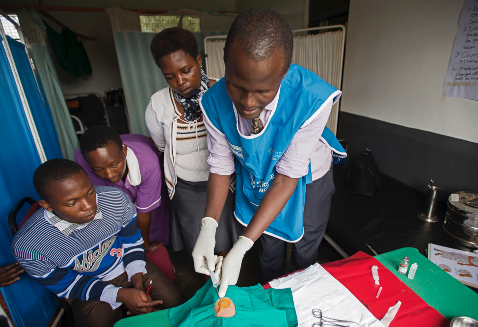 Man demonstrating implant removal to three people