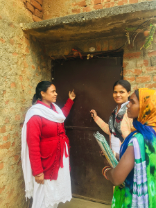 Three women standing outside a door