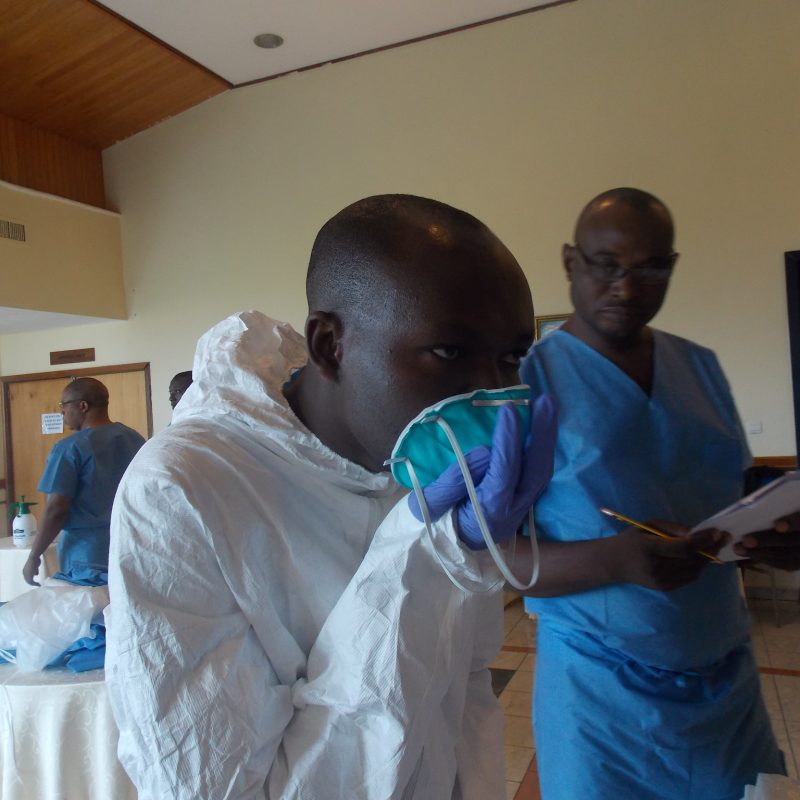 Health worker putting on a mask.