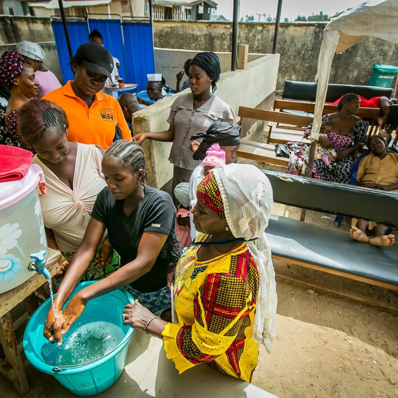 Women washing hands.