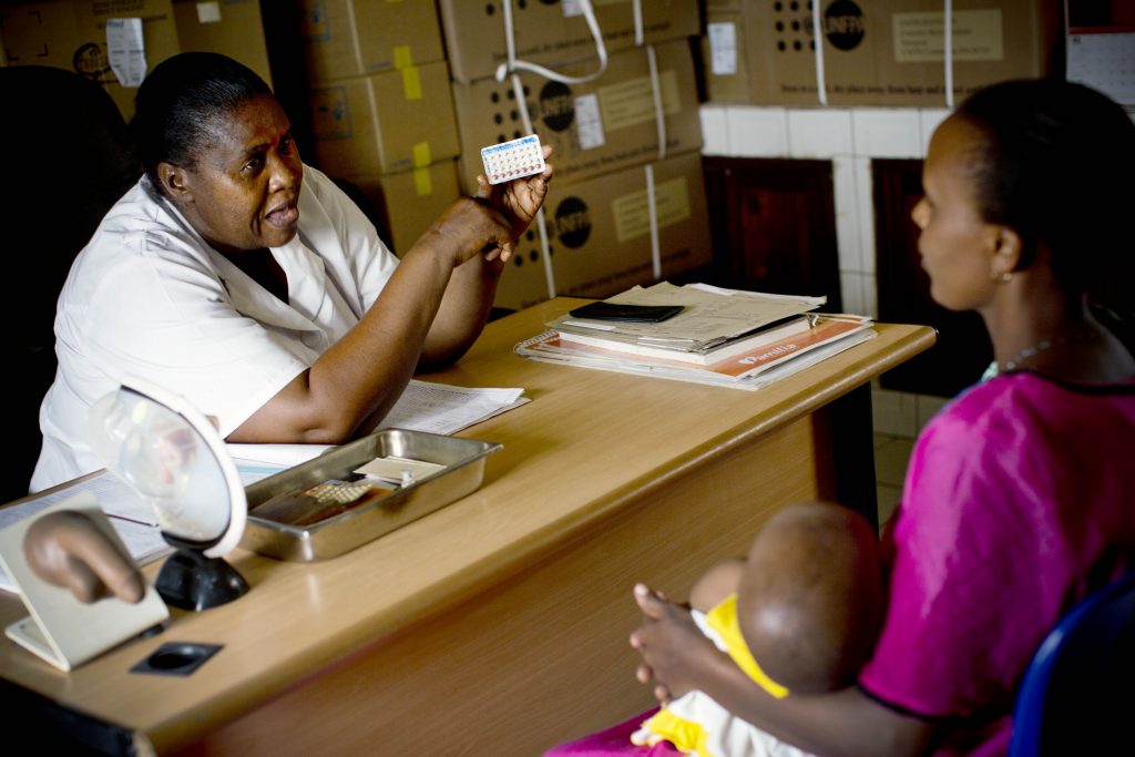 Health worker discusses family planning with a Tanzanian mother.