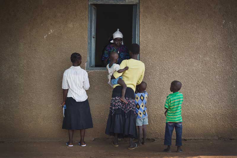 Mother and children at dispensary window, Sudan