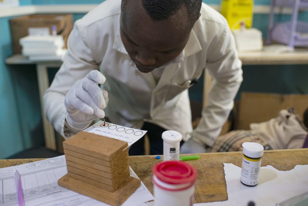 A Lab technician tests a baby for HIV at the Maragua Sub-County hospital in Maragua, Kenya.