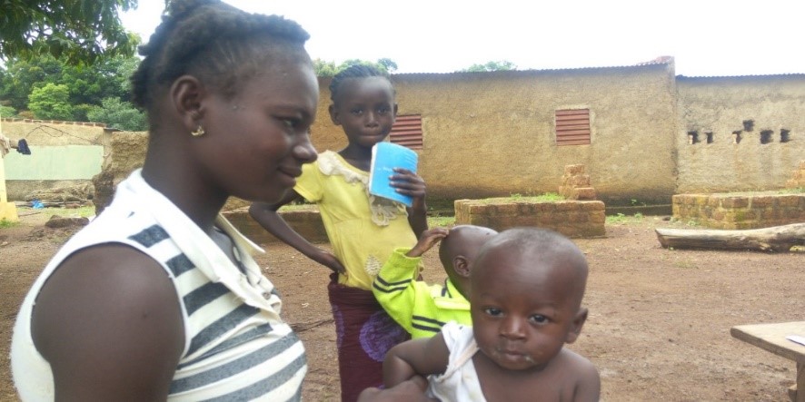 A woman with three young children.